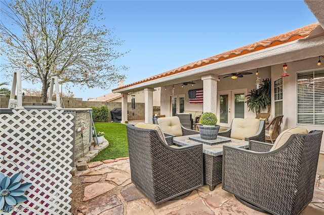 view of patio with area for grilling, ceiling fan, an outdoor hangout area, fence, and french doors