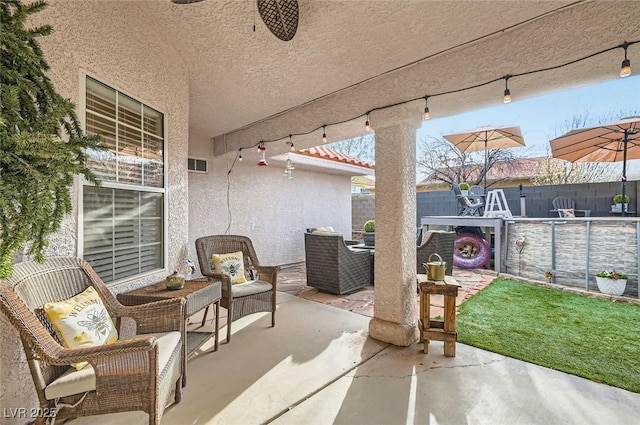 view of patio / terrace featuring fence and visible vents