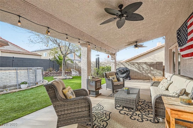 view of patio / terrace with a fenced in pool, area for grilling, ceiling fan, a fenced backyard, and outdoor lounge area