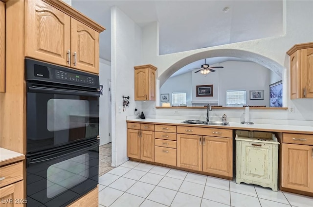 kitchen featuring light countertops, dobule oven black, a sink, and ceiling fan