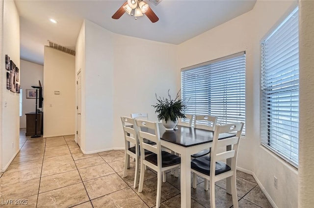 dining area with ceiling fan, light tile patterned flooring, visible vents, and baseboards