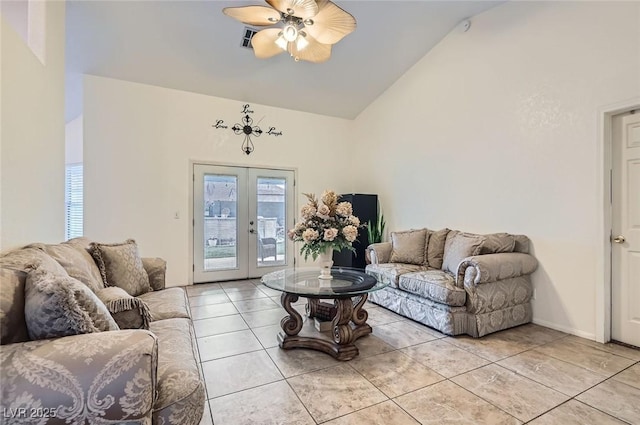 living area with light tile patterned floors, baseboards, lofted ceiling, ceiling fan, and french doors