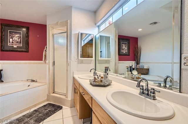 full bathroom featuring a garden tub, a sink, visible vents, and tile patterned floors