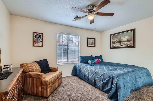 carpeted bedroom with visible vents, a ceiling fan, and a textured ceiling