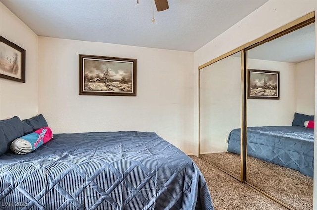 bedroom with a closet, a ceiling fan, and carpet flooring