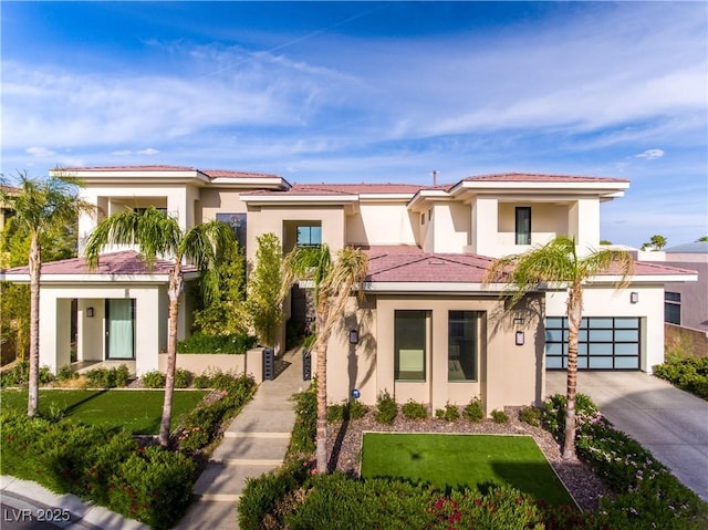 view of front of property featuring driveway, a tiled roof, an attached garage, and stucco siding