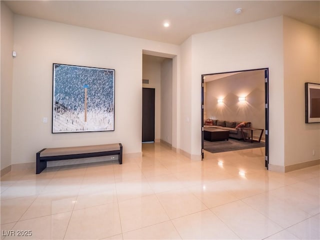 corridor featuring light tile patterned floors, recessed lighting, and baseboards