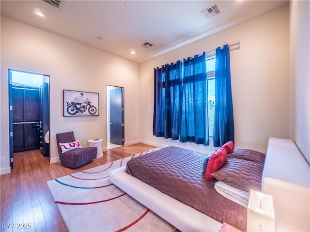 bedroom with recessed lighting, visible vents, and wood finished floors