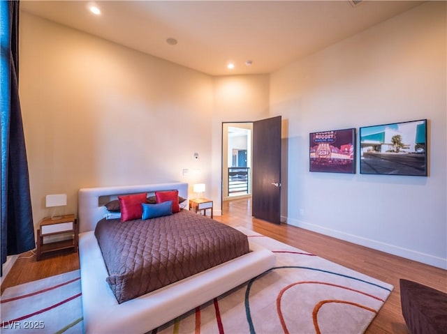 bedroom featuring recessed lighting, wood finished floors, and baseboards