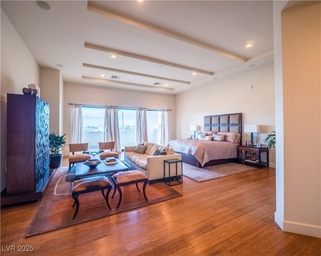 bedroom with recessed lighting, wood finished floors, visible vents, and baseboards