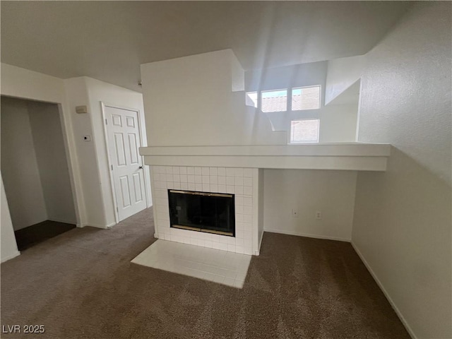 unfurnished living room with carpet, a fireplace, and baseboards