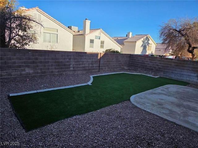 view of yard with a patio area and a fenced backyard