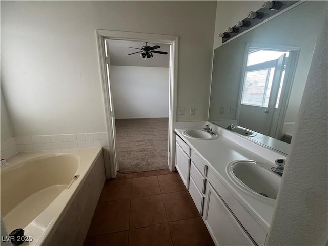 full bath with a bath, tile patterned flooring, double vanity, and a sink