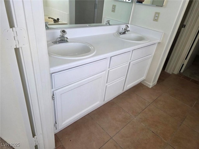 full bath featuring double vanity, a sink, and tile patterned floors