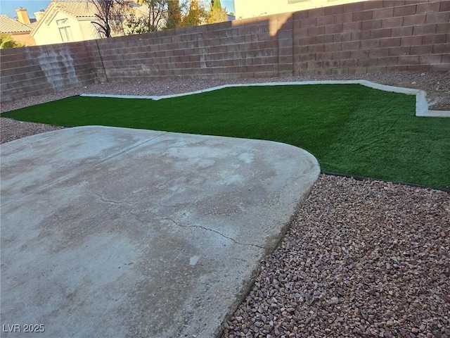 view of yard with a fenced backyard and a patio