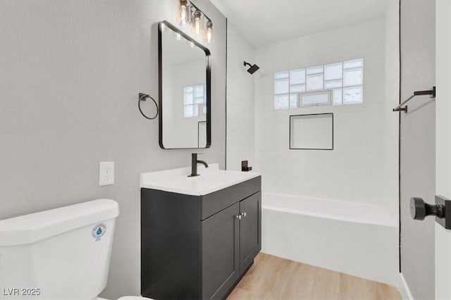 full bathroom with vanity, shower / bathing tub combination, wood finished floors, and toilet