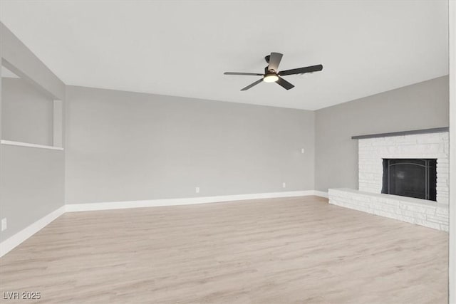 unfurnished living room with light wood-style floors, a fireplace, baseboards, and ceiling fan