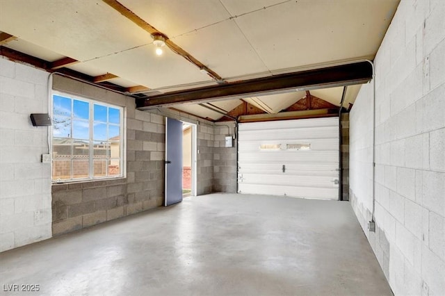 garage with concrete block wall