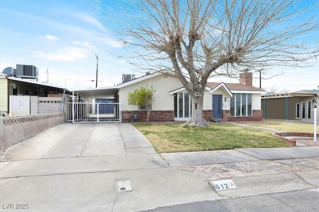 single story home featuring concrete driveway, fence, central air condition unit, a front lawn, and brick siding