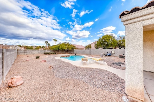 view of pool with a patio area, a fenced backyard, and a pool with connected hot tub