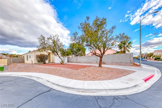 view of front of home with a fenced front yard and stucco siding