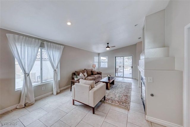 living room with light tile patterned floors, recessed lighting, a ceiling fan, vaulted ceiling, and baseboards