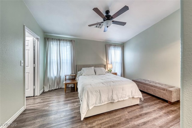 bedroom with visible vents, vaulted ceiling, ceiling fan, wood finished floors, and baseboards