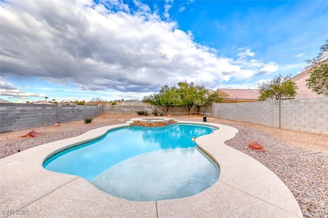 view of swimming pool with a fenced backyard and a pool with connected hot tub