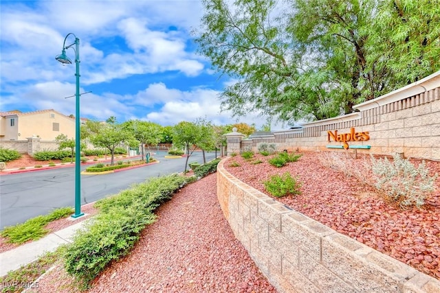 view of home's community featuring fence