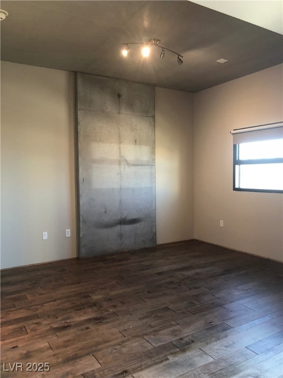 spare room with dark wood-type flooring