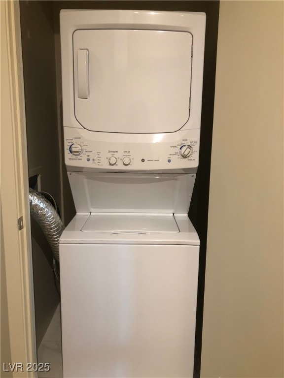 laundry area with stacked washer / dryer