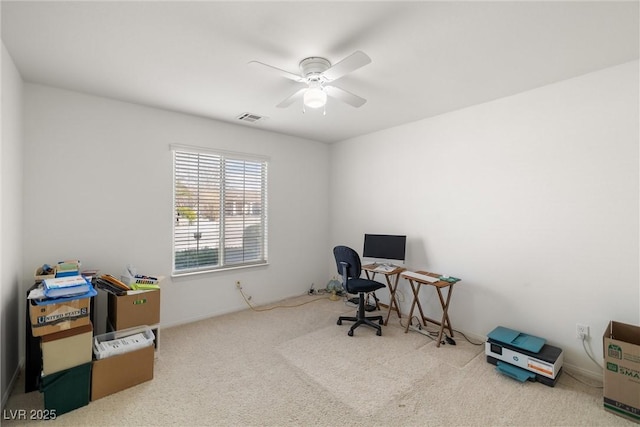 carpeted home office with visible vents and a ceiling fan