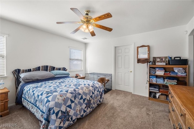 bedroom with carpet flooring, visible vents, and a ceiling fan