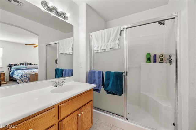 ensuite bathroom with a stall shower, tile patterned flooring, visible vents, and ensuite bath