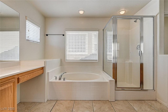 full bathroom featuring tile patterned flooring, a shower stall, a bath, and vanity