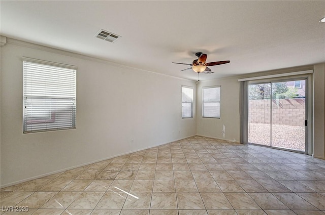 unfurnished room with crown molding, light tile patterned floors, visible vents, a ceiling fan, and baseboards