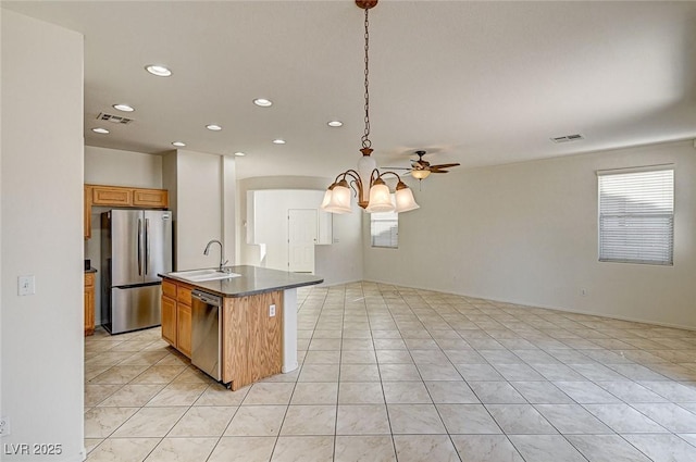 kitchen with light tile patterned flooring, a sink, visible vents, open floor plan, and appliances with stainless steel finishes