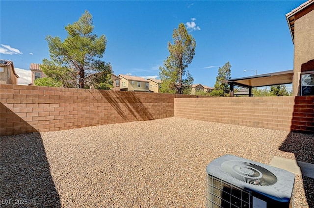 view of yard with a patio area, a fenced backyard, and central AC unit