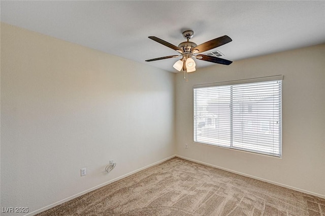 unfurnished room featuring light colored carpet, ceiling fan, visible vents, and baseboards