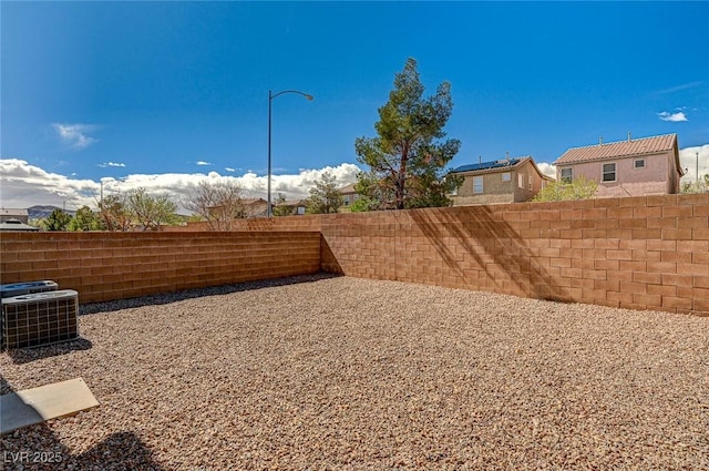 view of yard featuring cooling unit and fence