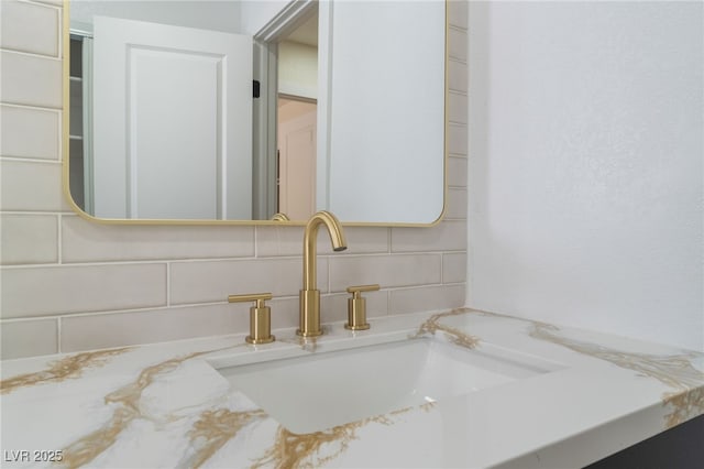 bathroom with tasteful backsplash and vanity