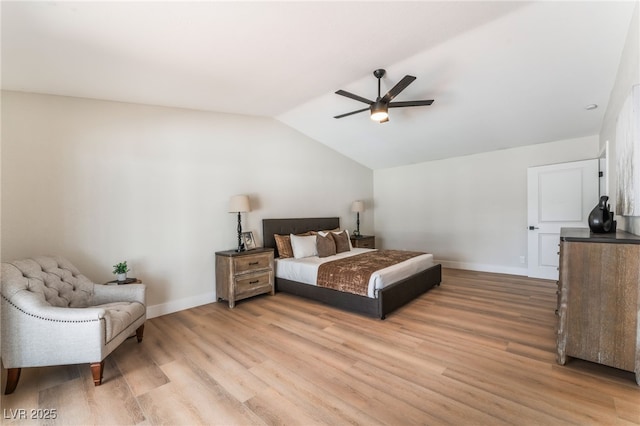 bedroom featuring vaulted ceiling, baseboards, a ceiling fan, and light wood-style floors