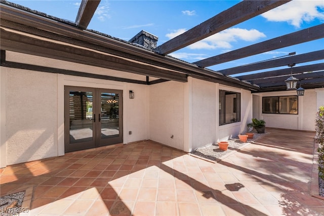 view of patio / terrace with glass enclosure and french doors