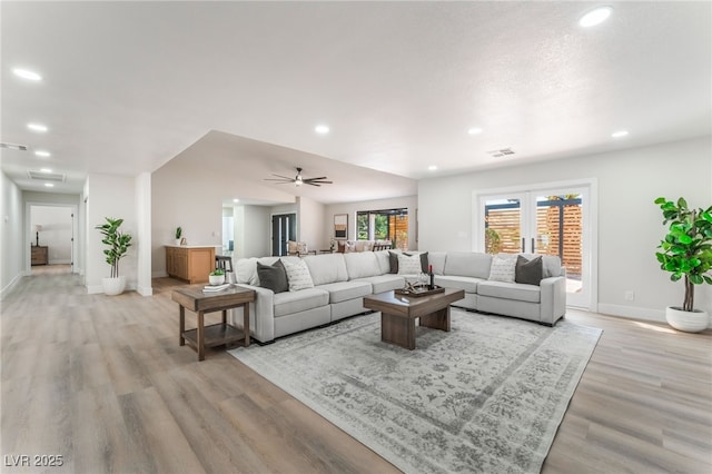 living room with light wood-style floors, recessed lighting, visible vents, and baseboards