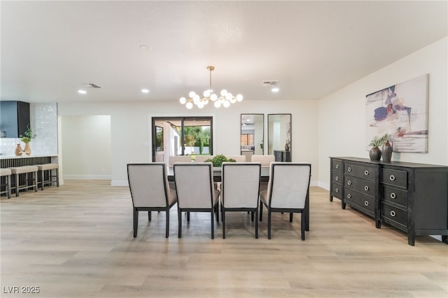 dining area with a chandelier, visible vents, light wood-style floors, and baseboards