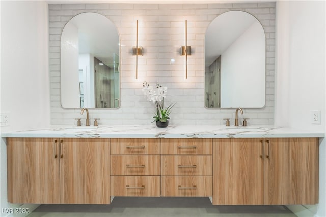 bathroom featuring a sink, decorative backsplash, and double vanity