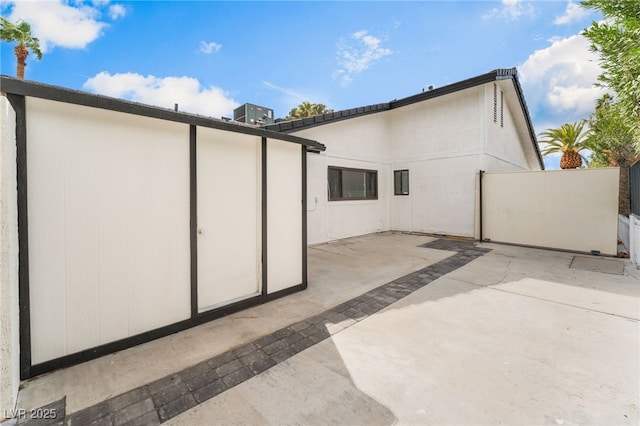 back of house featuring stucco siding, a patio, and fence