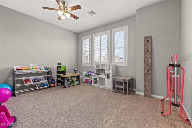 playroom with baseboards, carpet, visible vents, and a ceiling fan