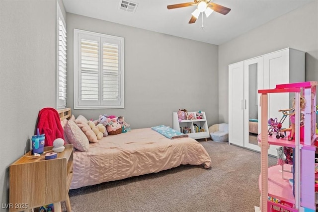 carpeted bedroom with visible vents and ceiling fan