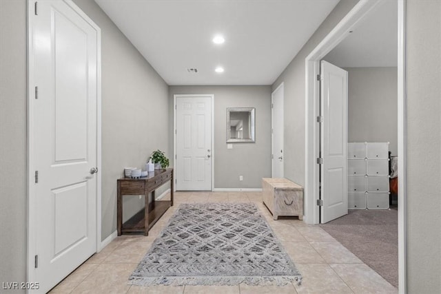 interior space featuring light tile patterned floors, recessed lighting, visible vents, and baseboards